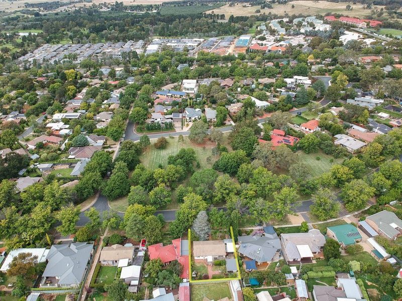An aerial view of a residential area with lots of trees and houses.