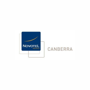 A blue and gold logo for novotel canberra