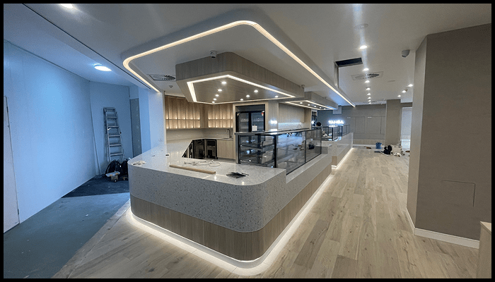 A large room with a long counter and a ceiling light.
