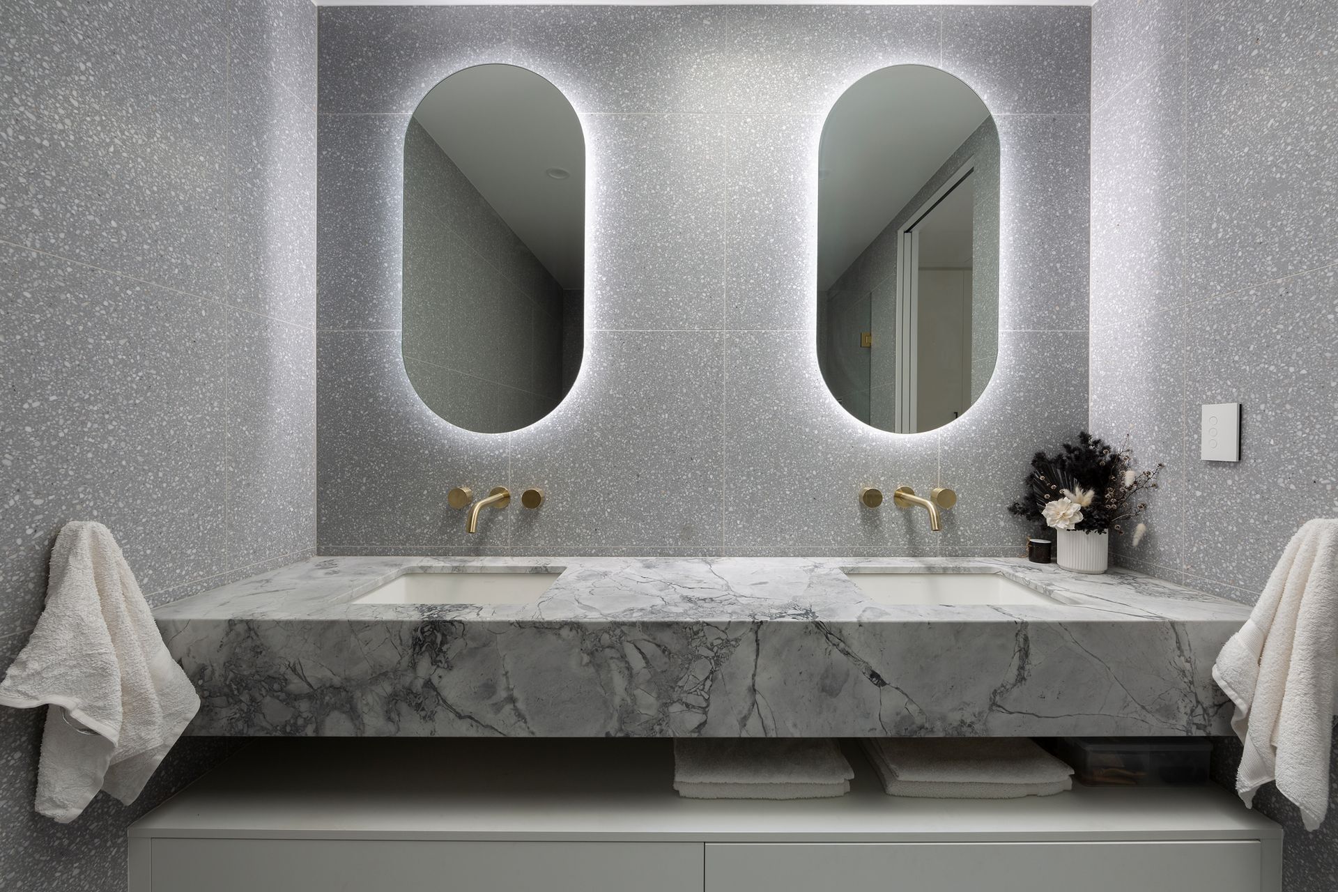 A bathroom with two sinks and two mirrors.