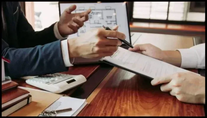 Insurance agent assisting a homeowner with fire damage claims paperwork