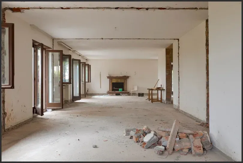 Fire-damaged home interior with debris and exposed walls during restoration