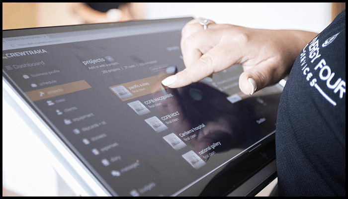 Cleaning staff using digital scheduling software to manage Airbnb turnover cleaning tasks