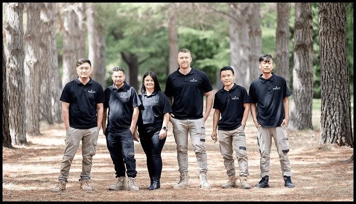 Team members of Synergy Four Services standing confidently outdoors in uniform, ready to provide professional strata cleaning in Canberra