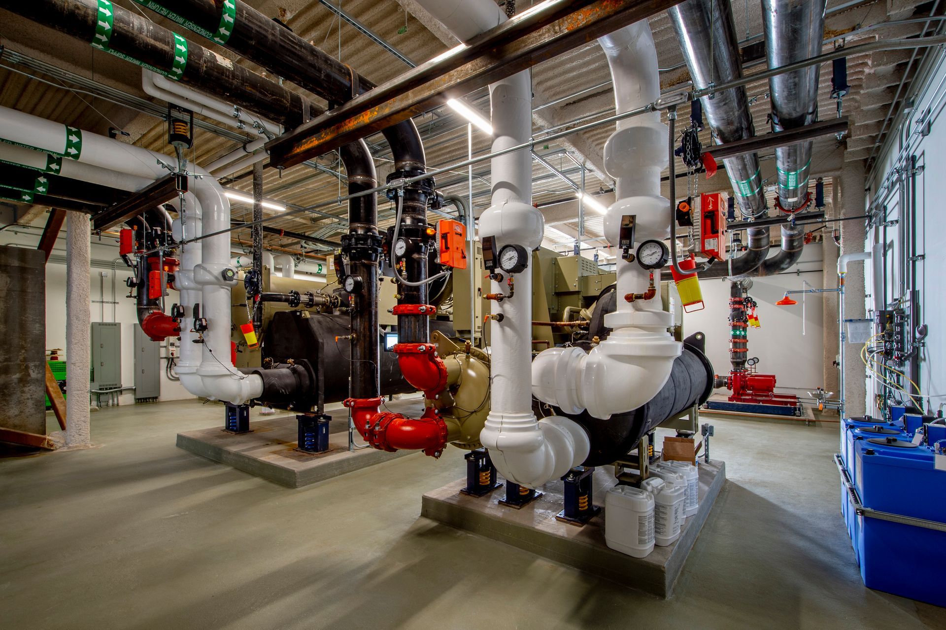 A factory with a lot of pipes and tubes in it.