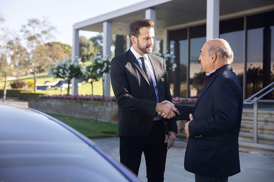 Staff member shaking hands with another man at HIllside