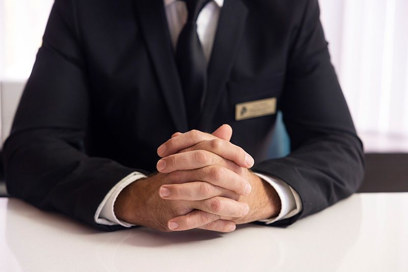 Man in business suit with hands together