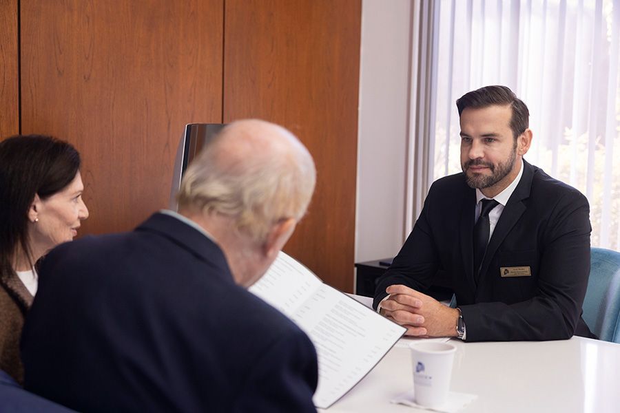 A man and a woman are sitting at a table having a conversation.