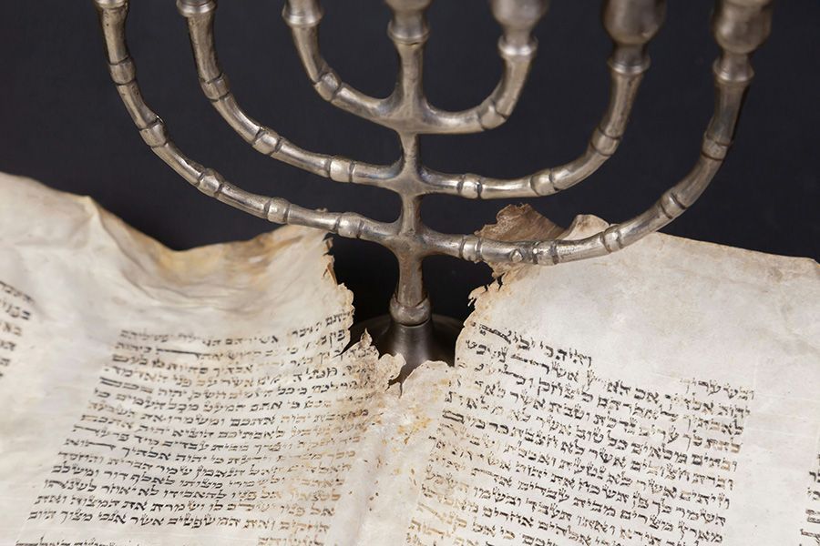 A menorah is sitting on top of an open book