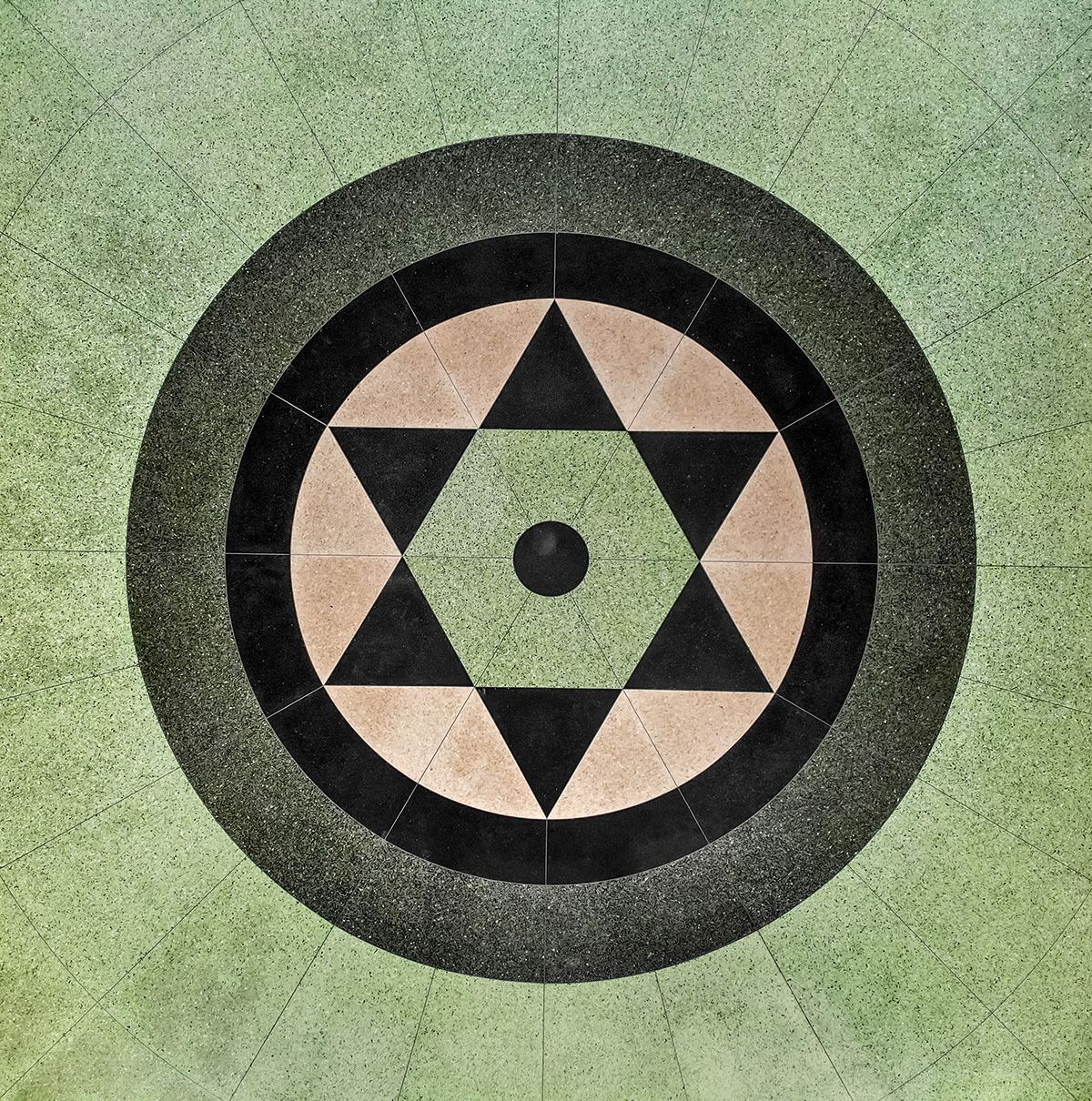 A circular pattern with triangles and a star in the center