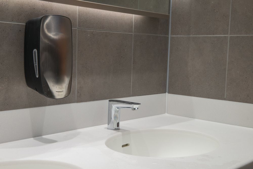 A Bathroom Sink With A Soap Dispenser On The Wall — Aafco Hygiene In Wodonga, VIC