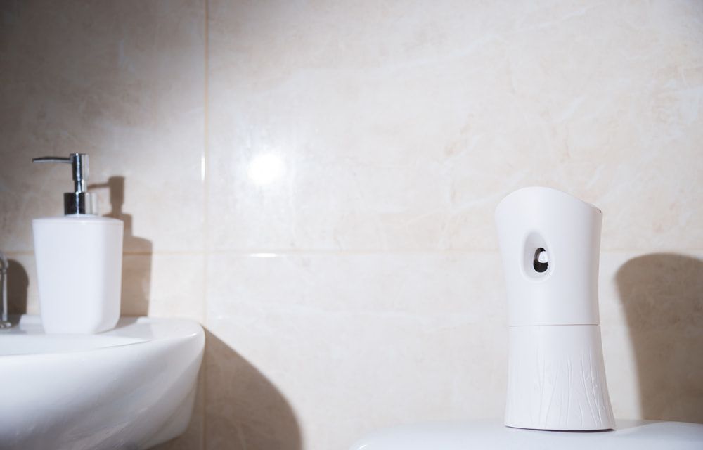 A Bathroom Sink With An Automatic Air Freshener Dispenser On The Wall — Aafco Hygiene In Wodonga, VIC