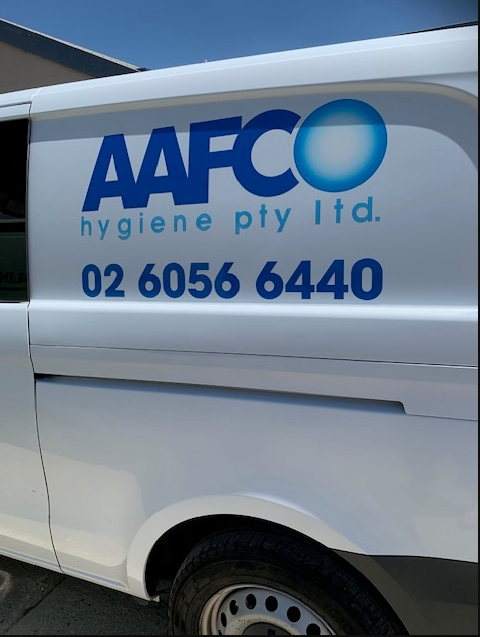 A Woman In Yellow Gloves Is Holding A Blue Bucket Filled With Cleaning Supplies — Aafco Hygiene In Wodonga, VIC