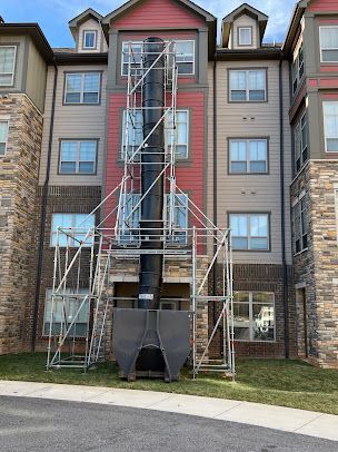 A large apartment building with scaffolding on the side of it.