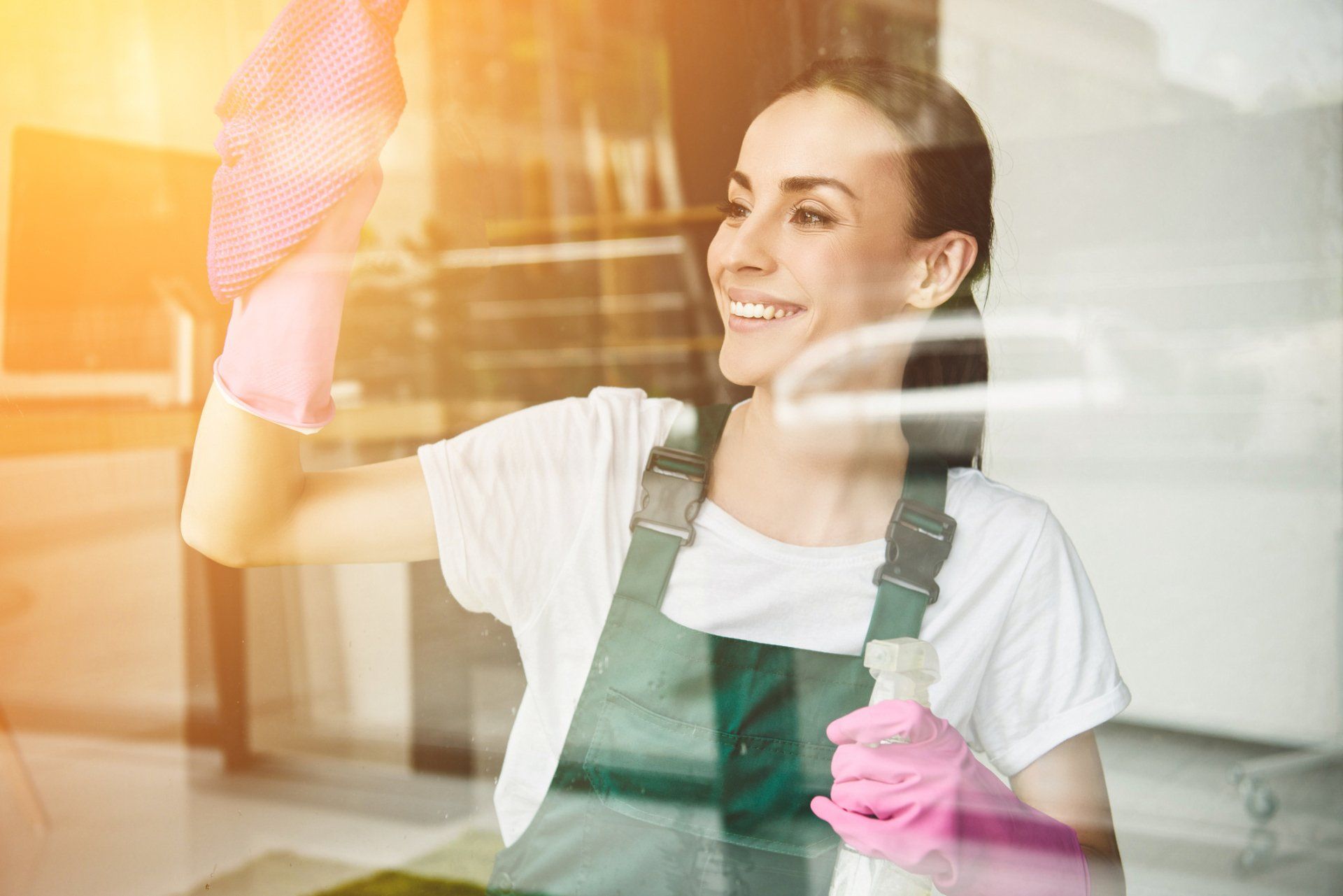 A Woman Cleaning A Window — Garden City, KS — Southwest Janitorial Service
