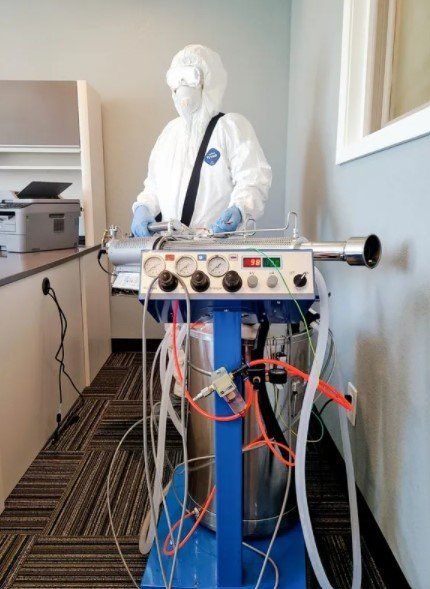 A Man On A PPE Suit With His Machine — Garden City, KS — Southwest Janitorial Service