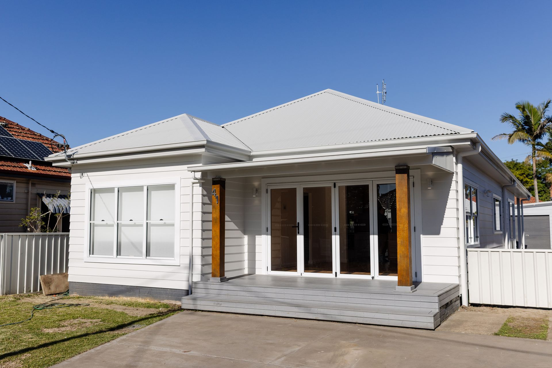 Builder and homeowner reviewing renovation plans and council approval documents in Newcastle