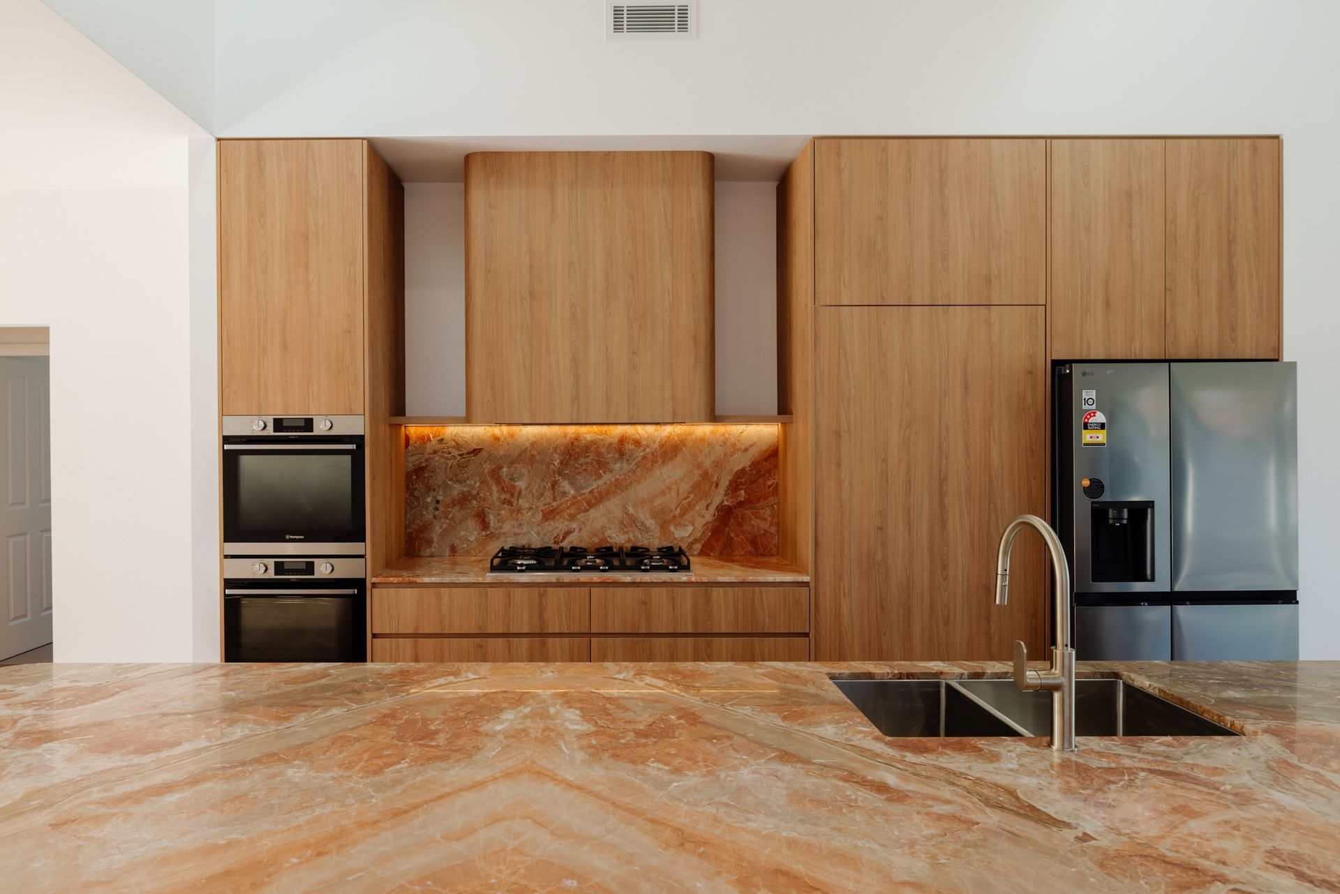 Entertainer's kitchen with raked ceiling in a renovated cottage at Scholey St, Mayfield — Altered Building & Renovations

