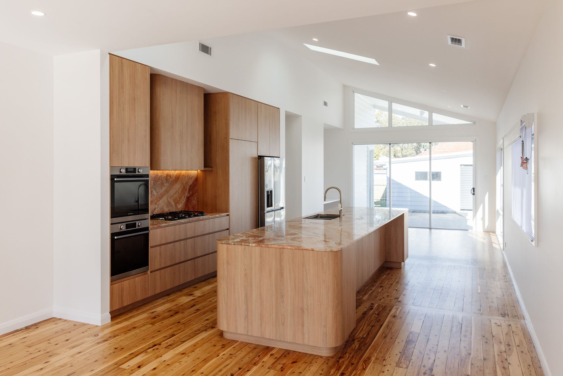 Entertainer's kitchen with raked ceiling in a renovated cottage at Scholey St, Mayfield — Altered Building & Renovations

