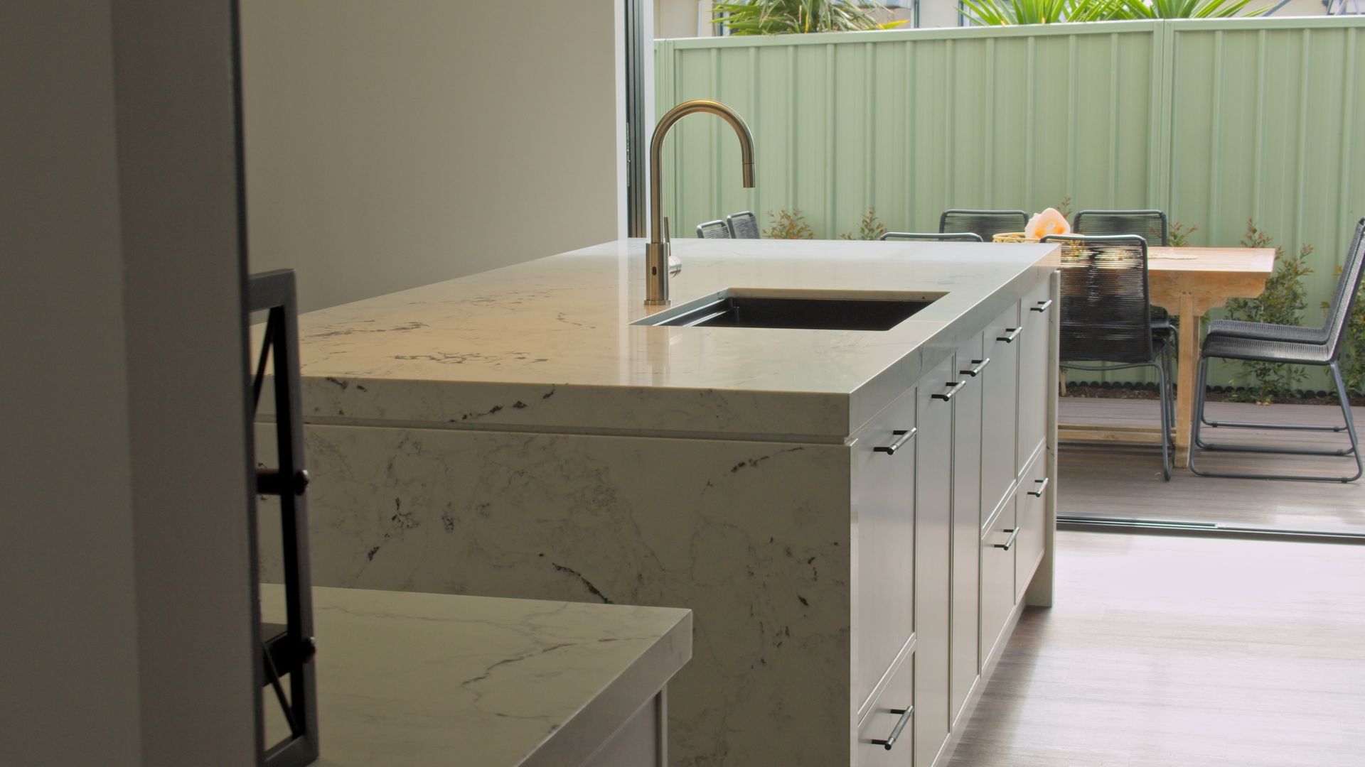 Modern kitchen renovation with large stone island benchtop, Newcastle NSW by Altered Building and Renovations