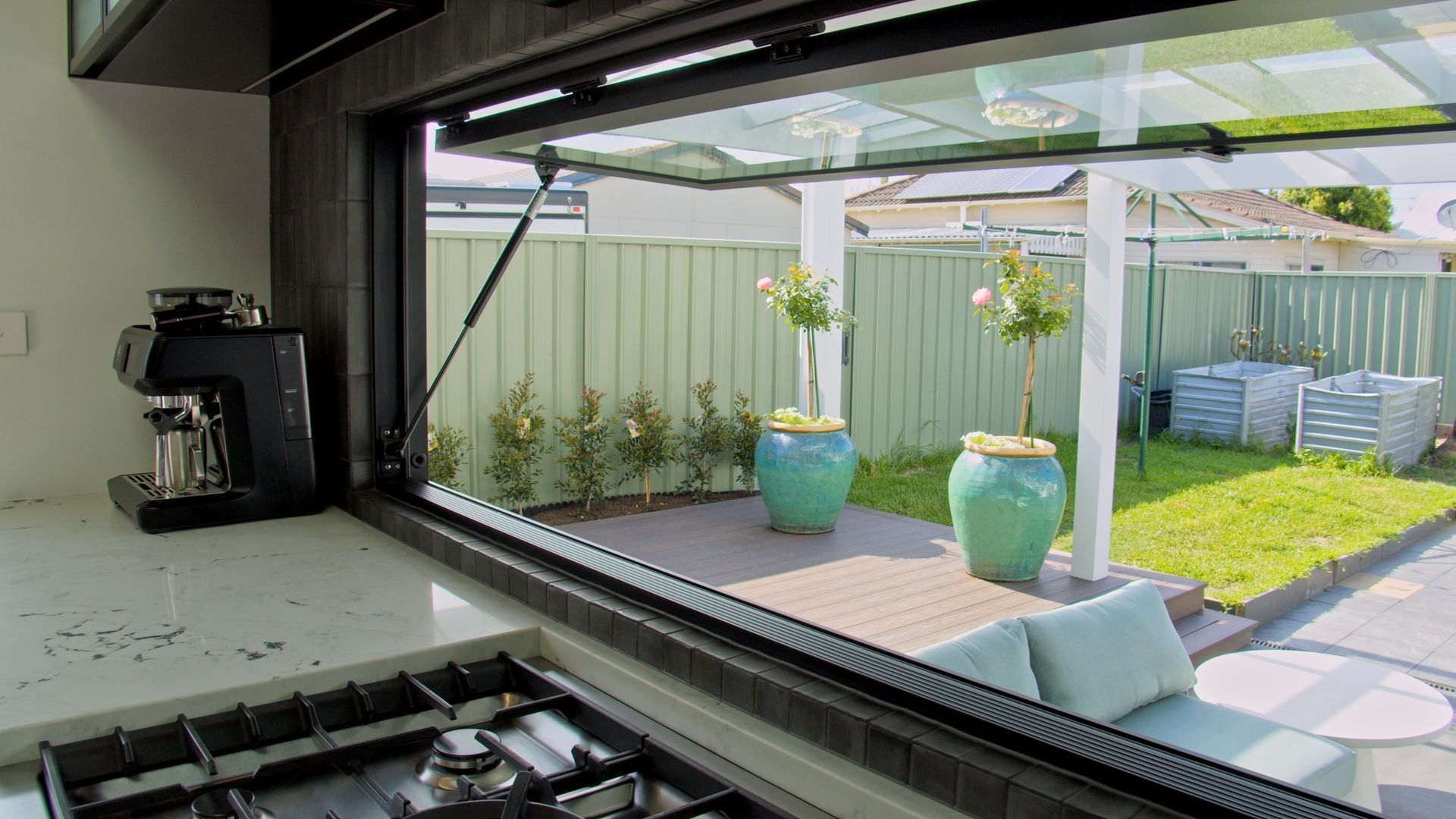 Renovated kitchen with large window opening to backyard, Newcastle home by Altered Building and Renovations