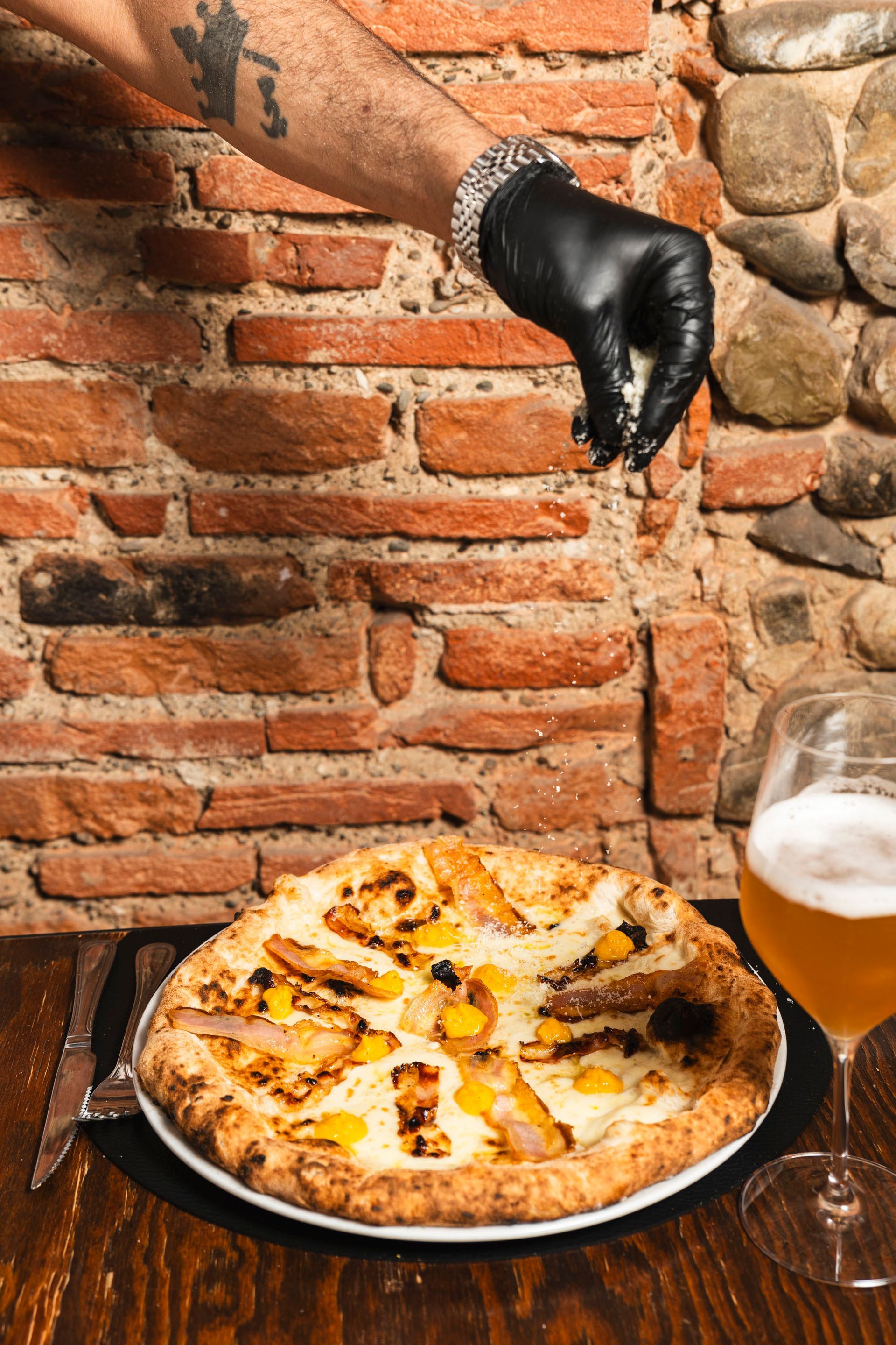 Pizza ricca di formaggio, condita con mais e prosciutto a cubetti su una crosta dorata.