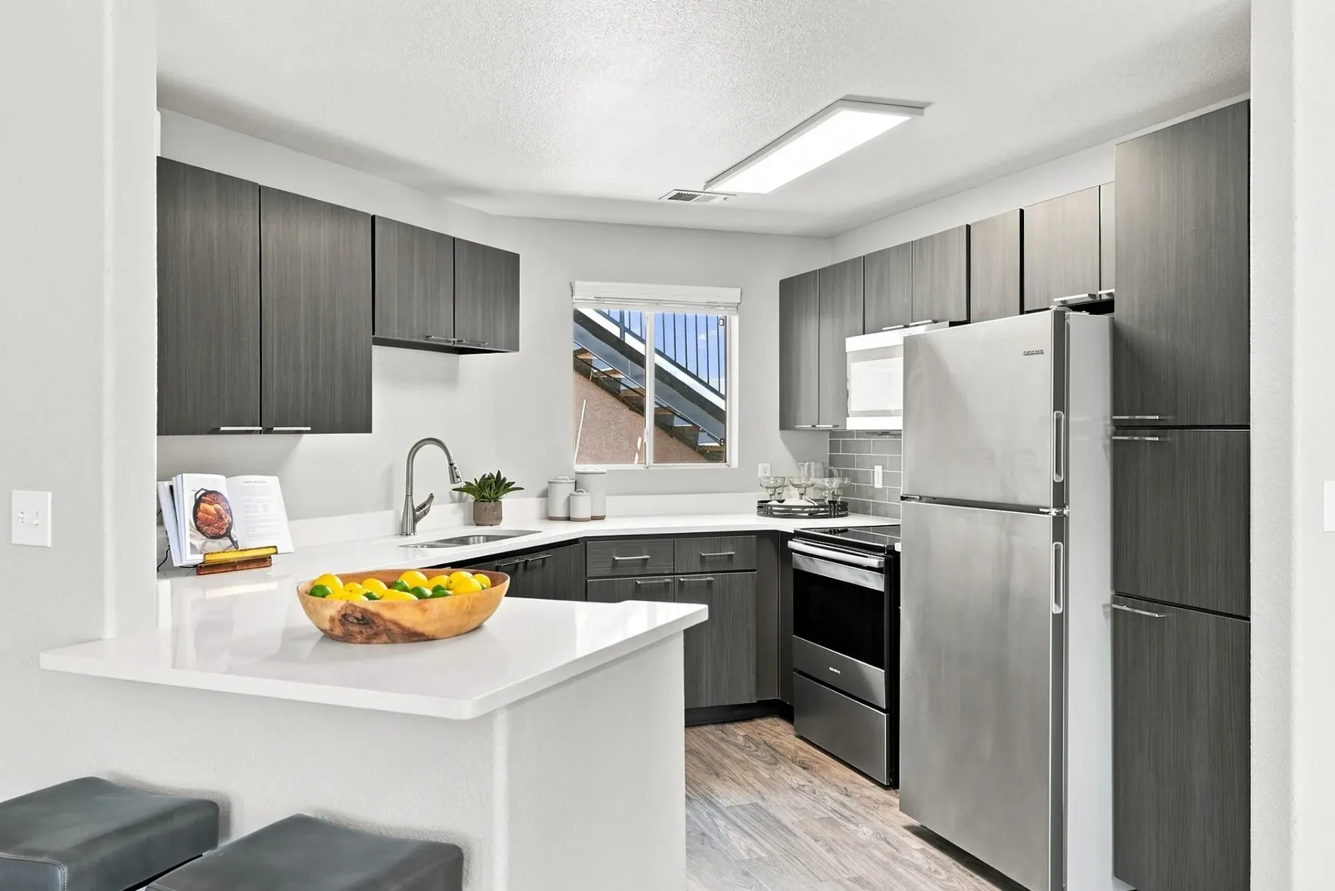 Modern kitchen with stainless steel appliances and dark wood cabinets at Broadstone Heights, offering apartments in Albuquerque, NM.