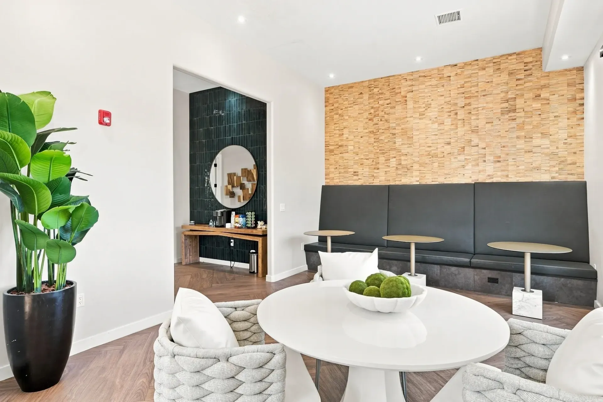 Lobby area with a coffee bar, seating, and a coffee table at Broadstone Heights, offering apartments in Albuquerque, NM.