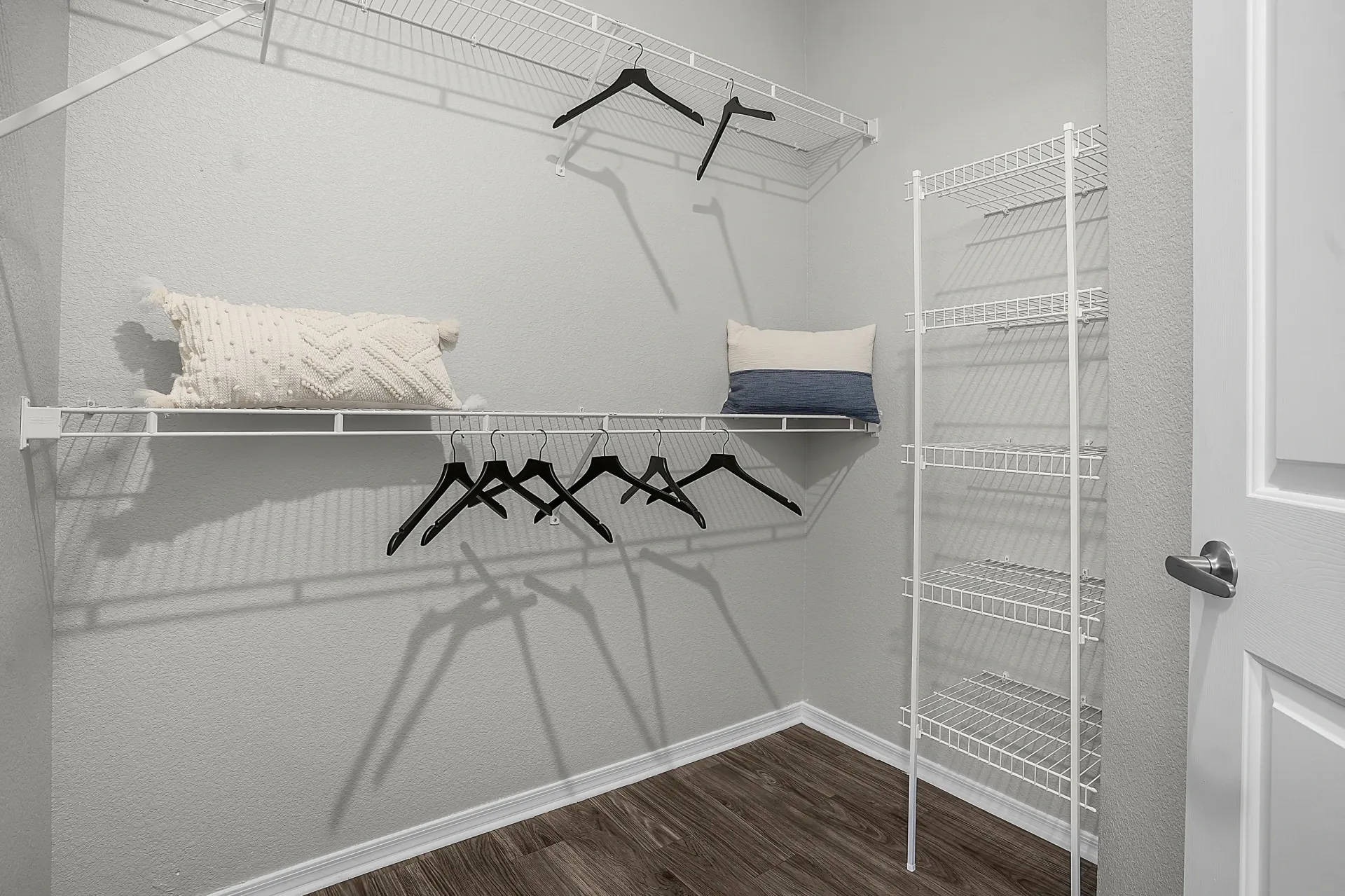 Walk-in closet with white wire shelving and hangers at Broadstone Heights, offering apartments in Albuquerque, NM.