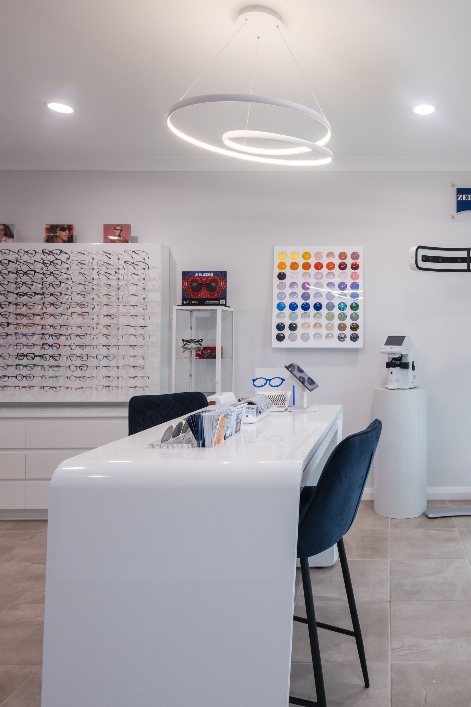 Bright dental clinic interior with a treatment chair, examination lamp, and wall charts