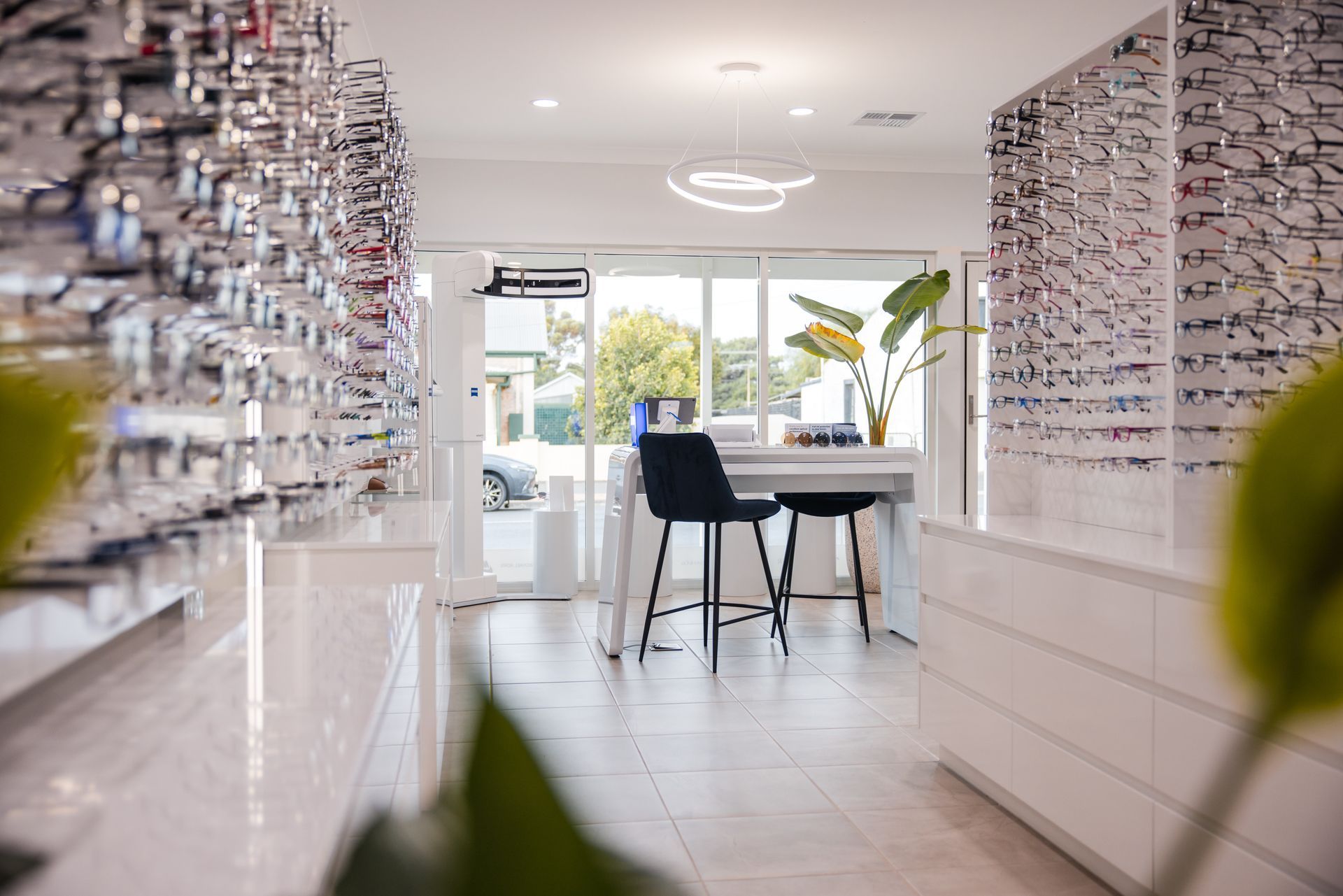 Bright eyewear showroom with wall displays and a table by a front window