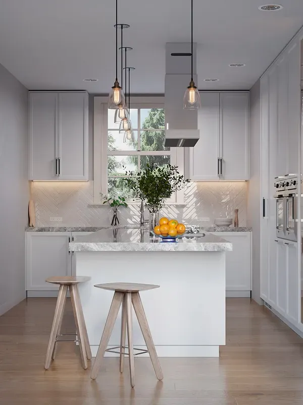 A kitchen with white cabinets , a large island , stools and a window.