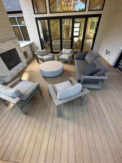 An aerial view of a deck with furniture and a fireplace.