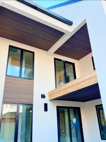 A house with a lot of windows and a wooden ceiling