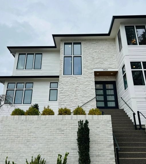 A large white house with stairs leading up to it