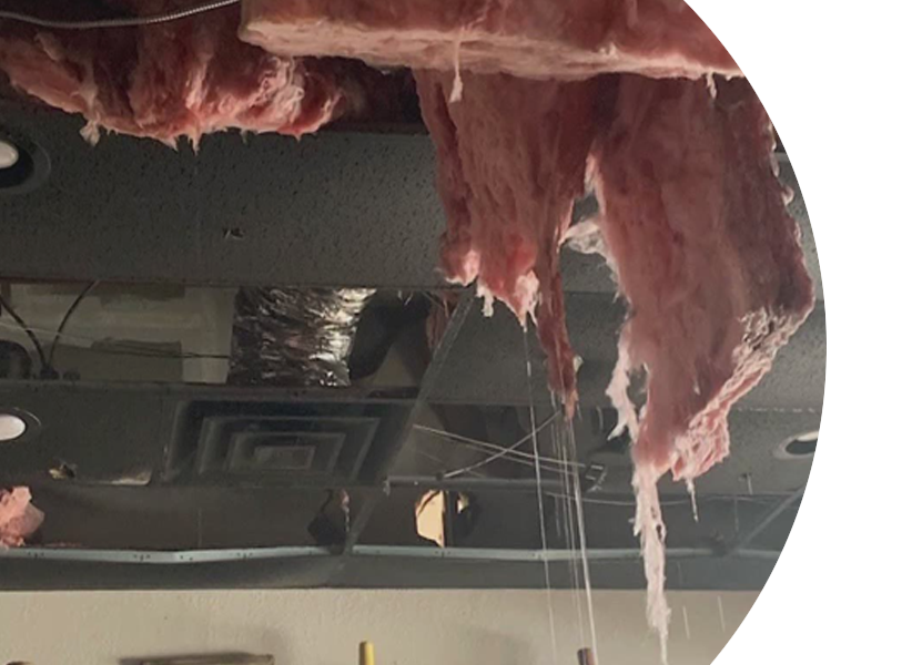 A piece of insulation is hanging from the ceiling