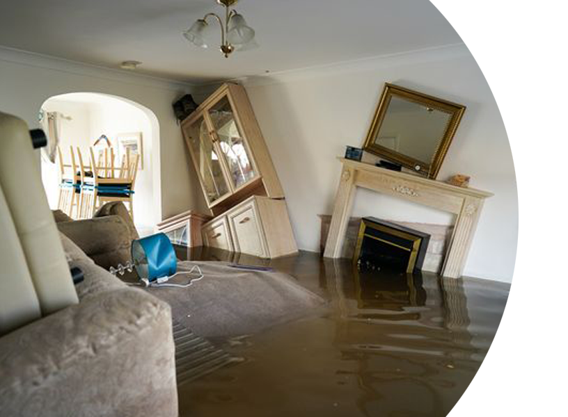 A flooded living room with a couch and a fireplace.