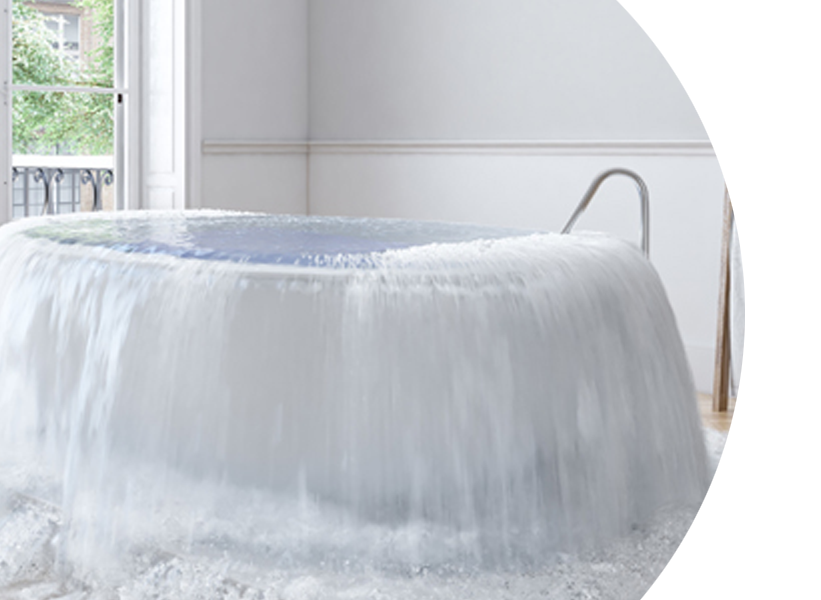 A bathtub is overflowing with water in a bathroom.