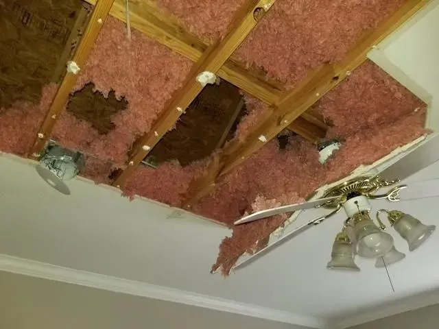 A ceiling fan is hanging from the ceiling of a room.