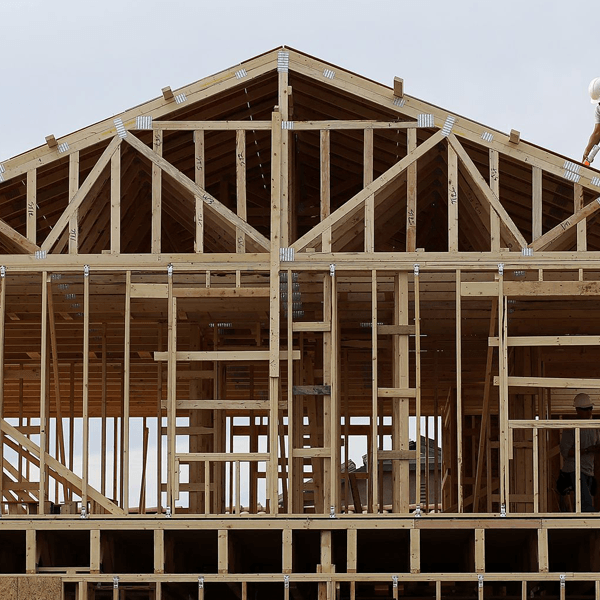 A house is being built with wooden beams and a roof in Queens, NY