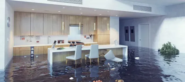 A kitchen and dining room are flooded with water.
