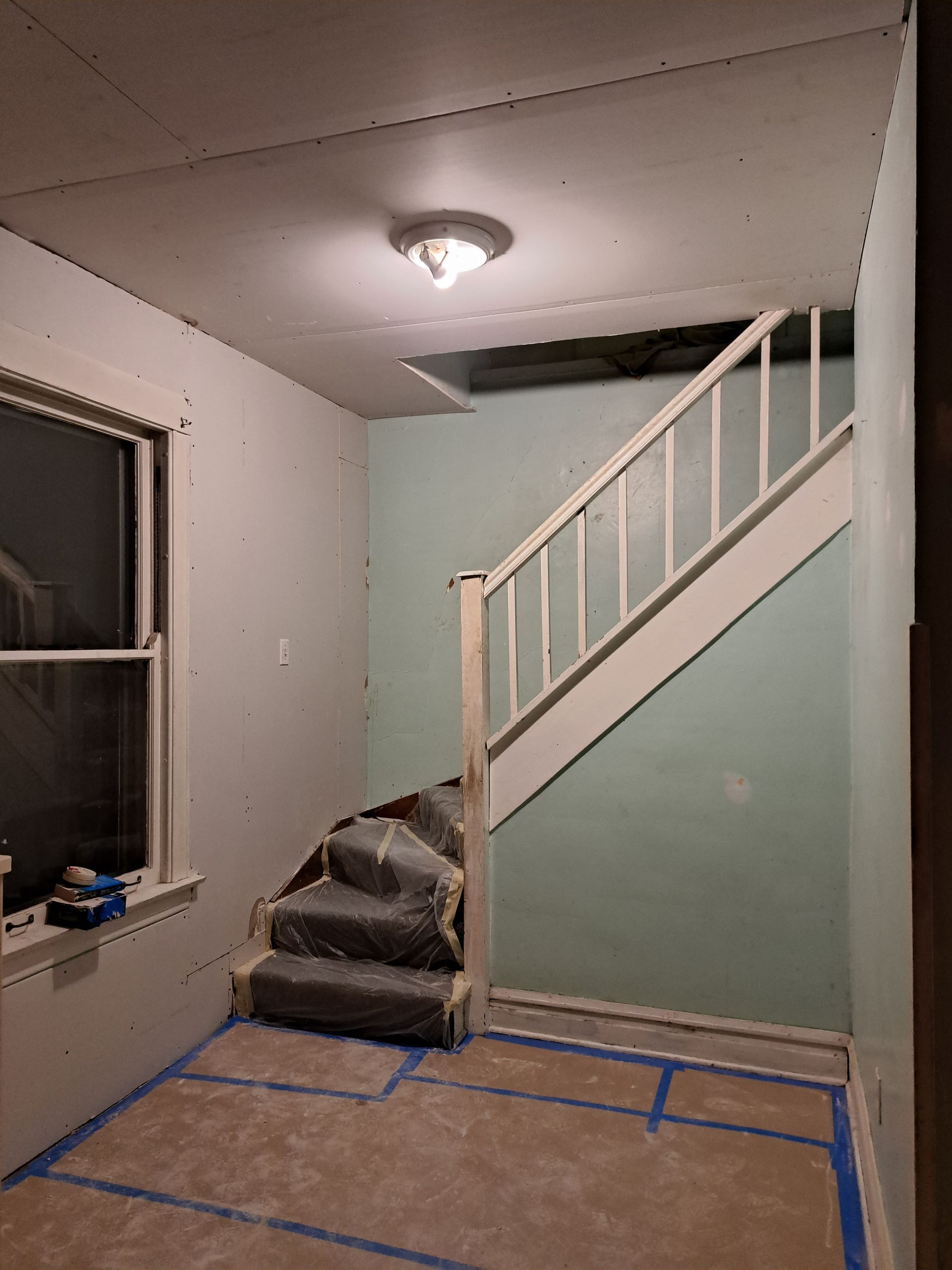 a person is painting a wall with a paint roller .