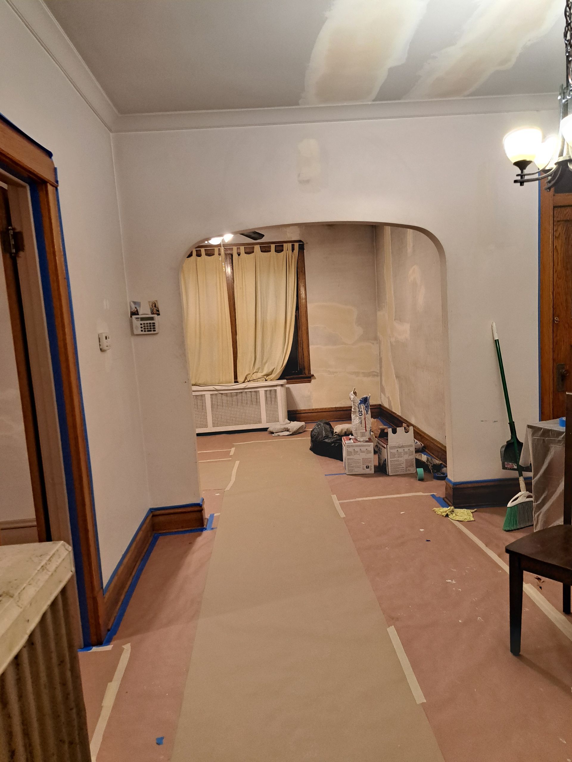 an empty room with a wooden floor and a ladder .