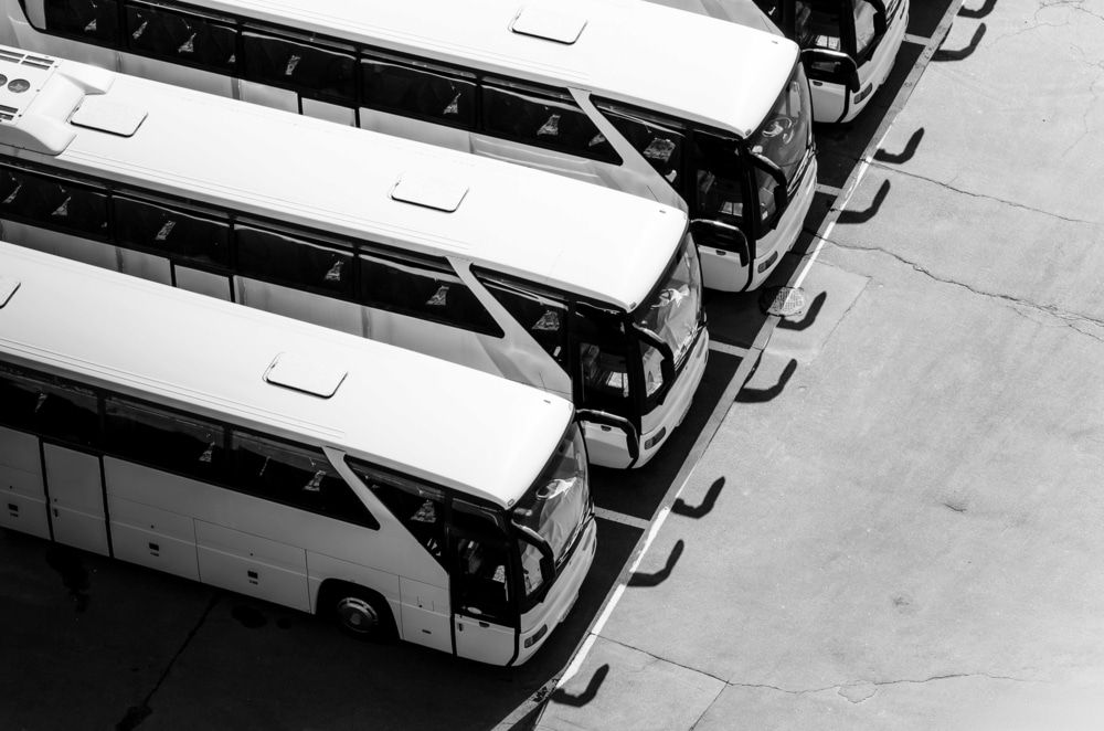 A Black And White Photo Of A Row Of Buses Parked In A Parking Lot — Cairns Mechanical Workshop In Bungalow, QLD