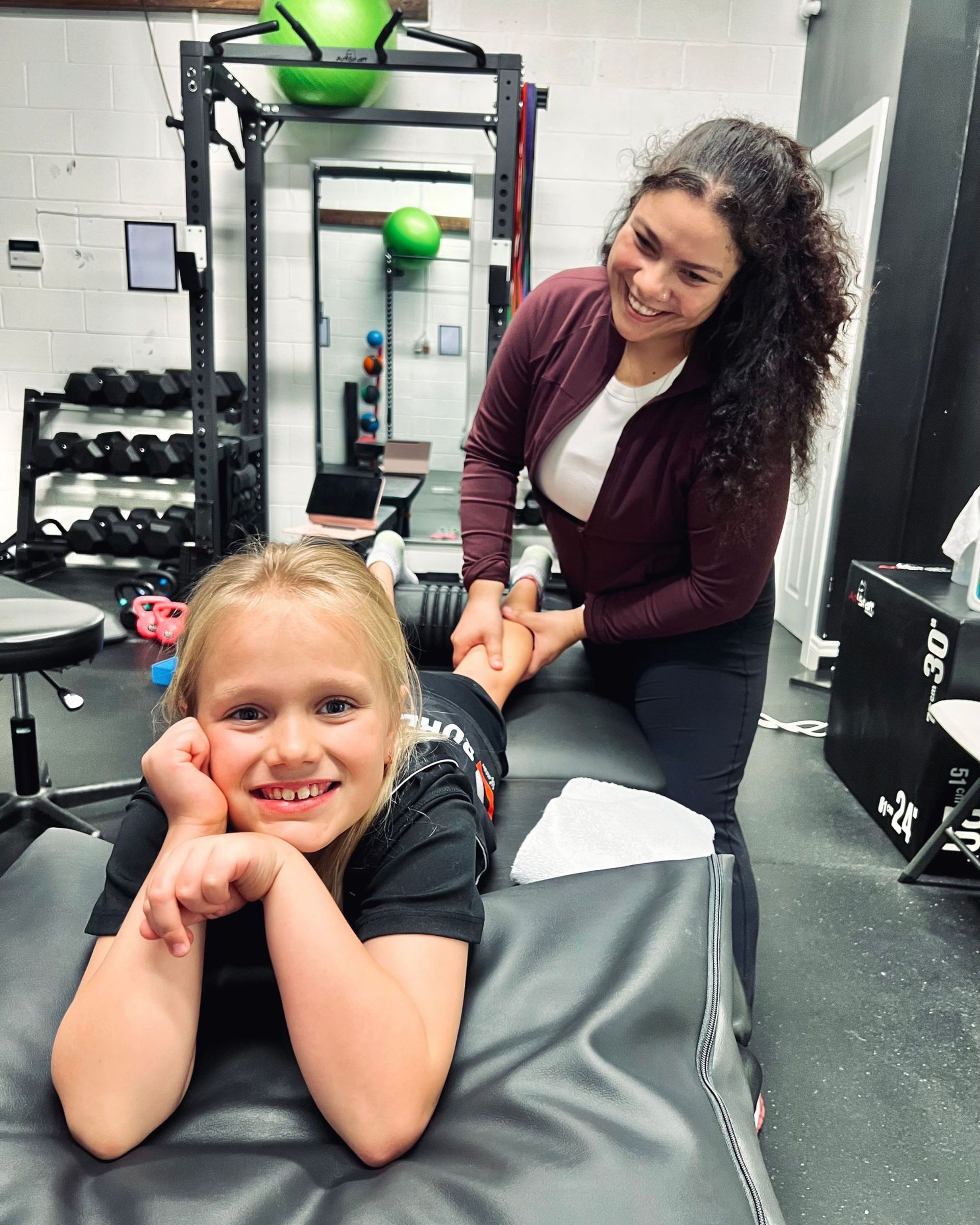 Athletic therapist guiding a patient through a mobility exercise