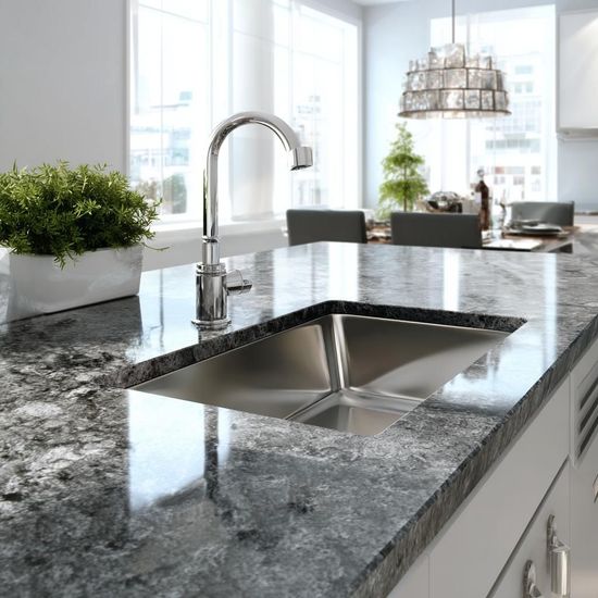 Modern kitchen with granite island, stainless double sink, and bright windows