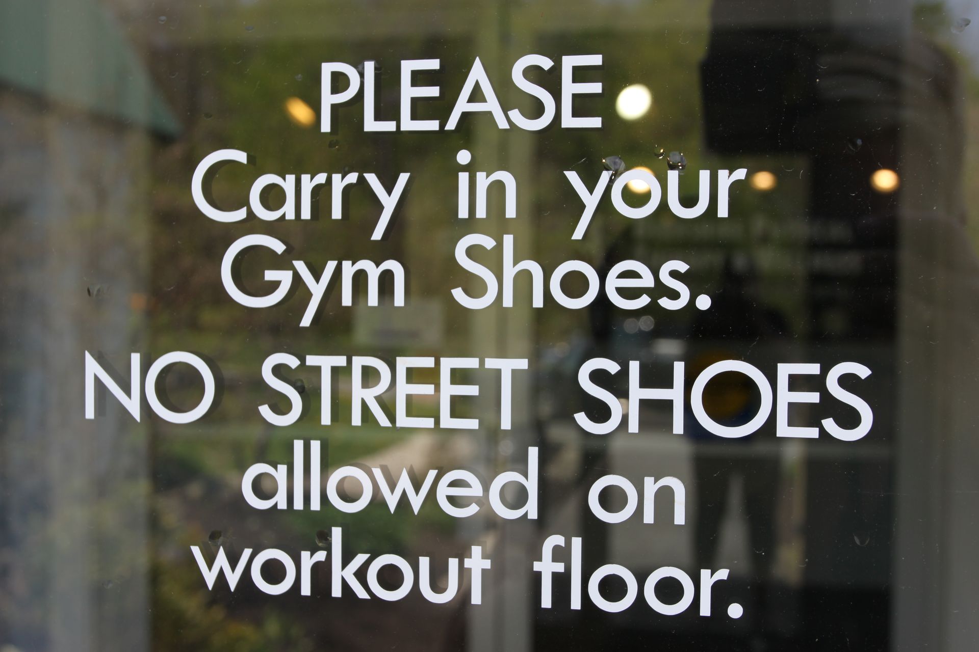 A sign on a glass door reads: 