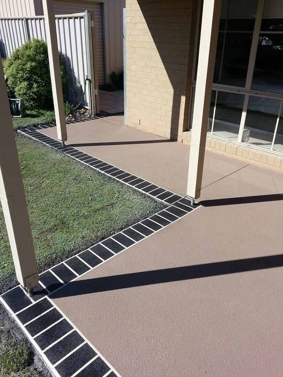 A Patio With A Concrete Walkway Leading To A House — Custom Concrete Finishes In Wodonga, NSW