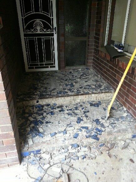 A Brick Porch With A Lot Of Broken Glass On The Floor — Custom Concrete Finishes In Thurgoona, NSW