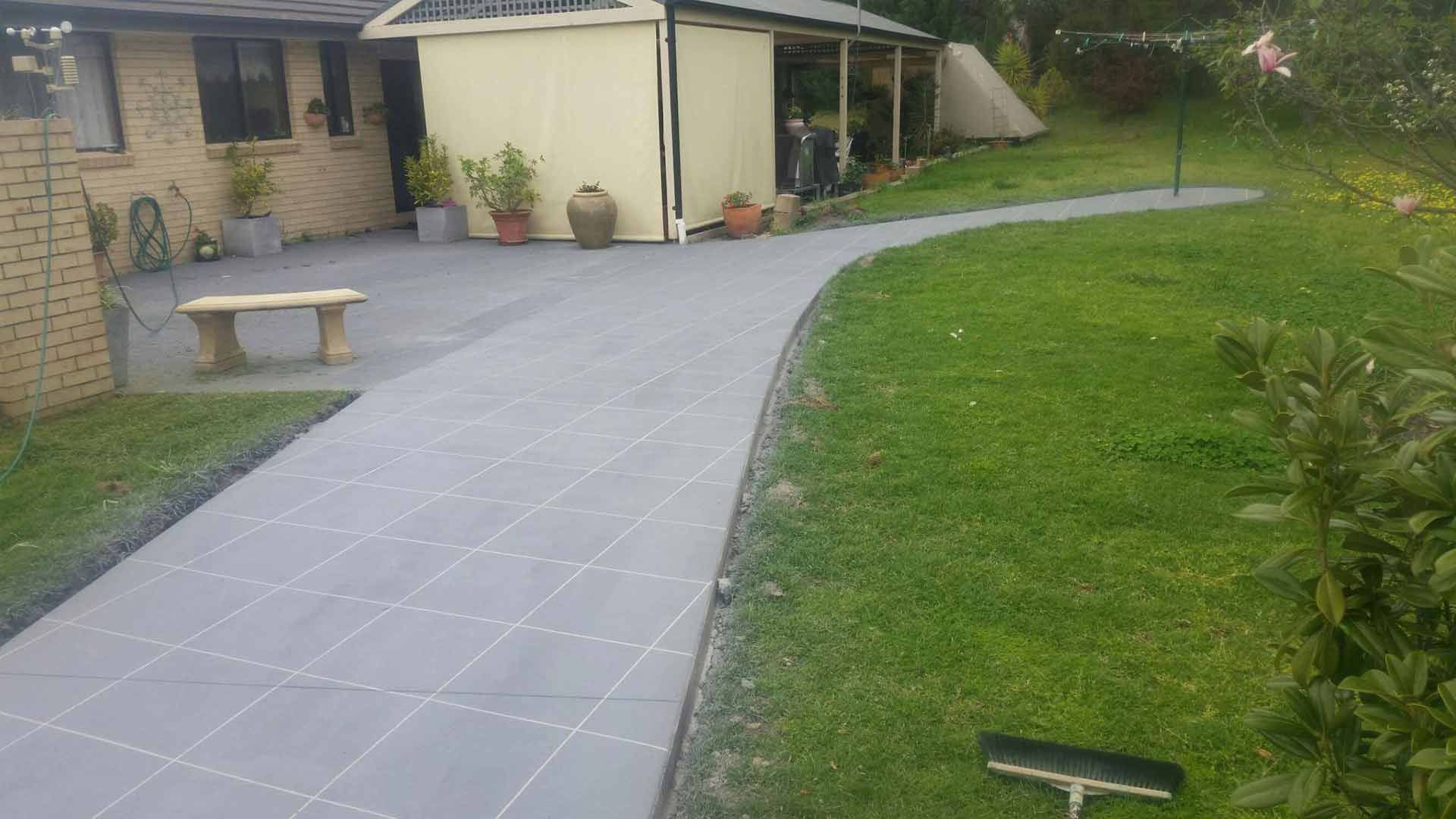 A Concrete Driveway Leading To A House With A Bench And A Shed — Custom Concrete Finishes In Killara, NSW
